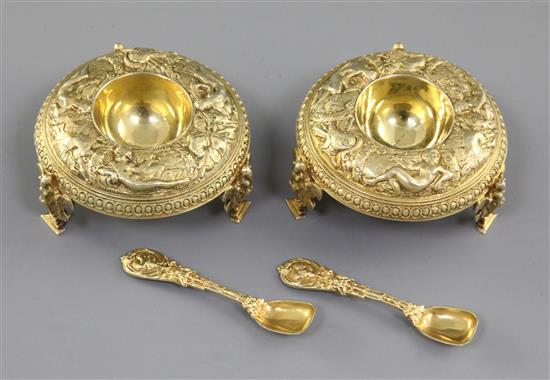 A good pair of Victorian cast silver gilt salt cellars and spoons, by Jane Brownett? height 40mm, weight 7.3 oz/230grms.